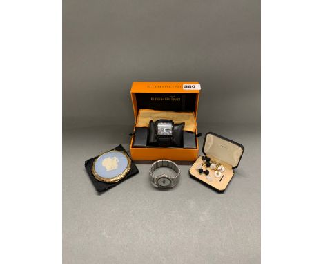 A Stuhrling boxed rainbow dial wristwatch, together with a further wristwatch, cufflinks and compact.