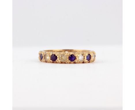 A 9ct yellow gold full eternity ring set with blue and white stones, (K).