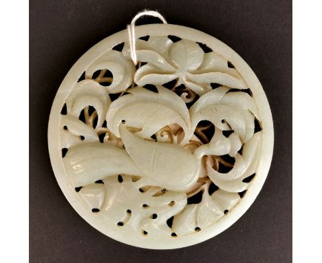 A Chinese carved celadon jade circular panel, Dia. 9.3cm (possibly from a box lid).