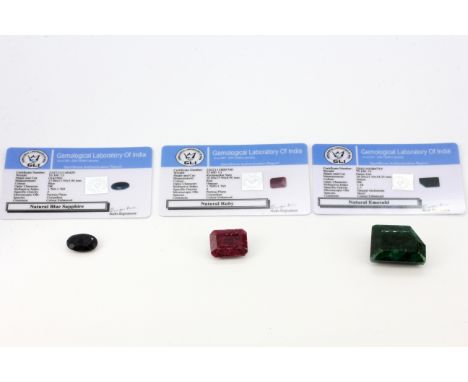 A group of three mixed unmounted gemstones consisting of a rectangle step cut ruby, approx. 32.6ct, a fancy cut natural emera