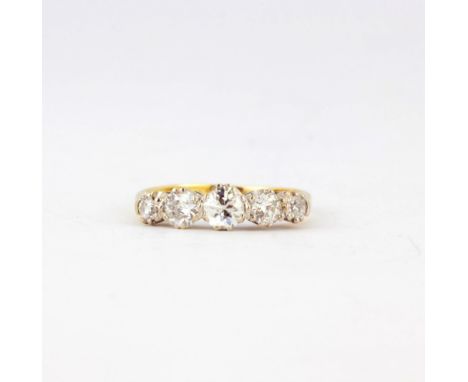 An 18ct yellow and white gold ring set with five graduated old cut diamonds, (K).
