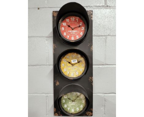 An interesting battery operated traffic light style metal triple wall clock, 30 x 80cm.