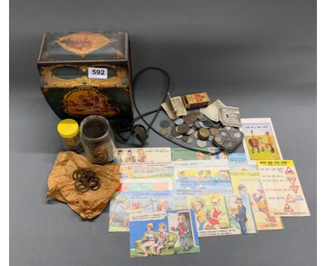 A sovereign case, a coin case and coins, a vintage advertising tin and a quantity of comic postcards.