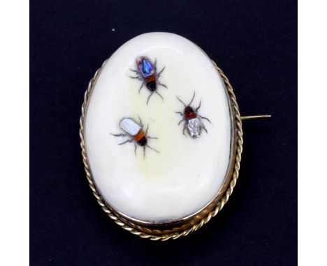 An early 9ct yellow gold (stamped 9ct) bone brooch inset with mother of pearl, L. 4cm.