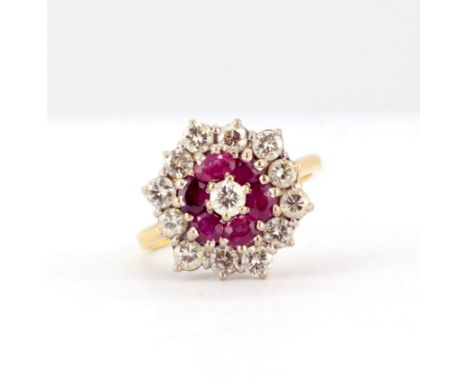 An 18ct yellow gold (stamped 18ct) cluster ring set with rubies and diamonds, (K).