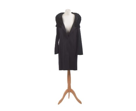 A coat by Amanda Wakeley, the mid-length black coat with faux fur shrug, size 12.Condition report: Overall condition good Sig
