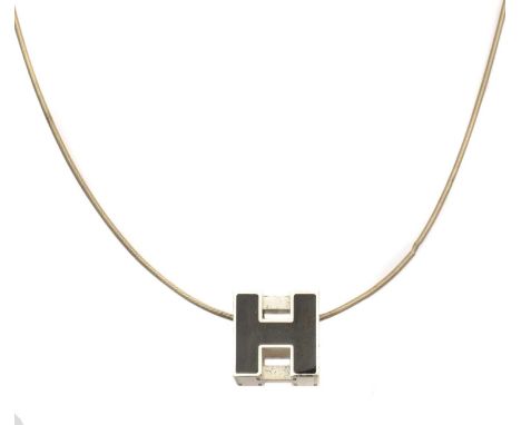 A Hermès Cube H necklace, the black enamel and stainless steel H pendant suspended from an accompanying cord chain, signed He