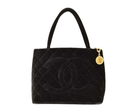 A Chanel Medallion Shoulder Bag, circa 1997-9, the black velvet quilted canvas exterior with black canvas strap and gold tone
