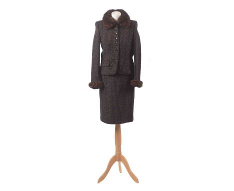 A suit by Escada, the brown and black woven wool suit comprising mid length skirt and jacket, the jacket with detatchable fur