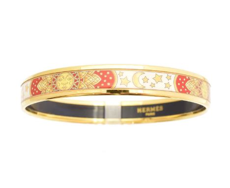 A Hermès enamel bangle bracelet, the red white and yellow enamel bangle with sun moon and stars decoration, and gold tone bor