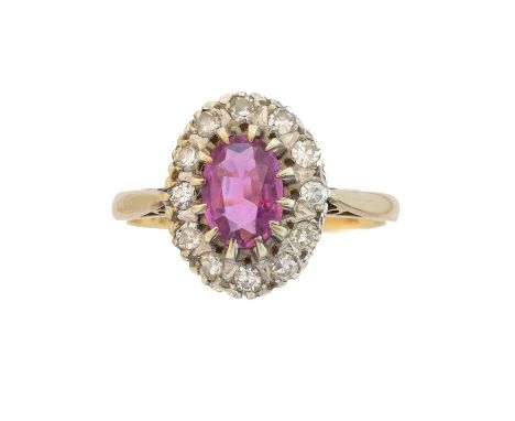 A 9ct gold ruby and diamond cluster ring, A 9ct gold ruby and diamond cluster ring, the oval shape ruby within a single cut d