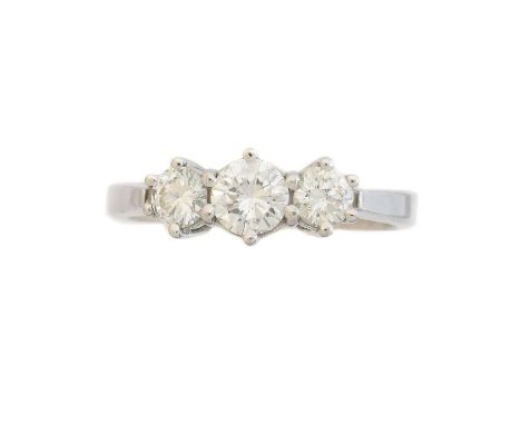 An 18ct gold diamond three stone ring, An 18ct gold diamond three stone ring, the brilliant cut diamond line with tapered sho