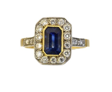 An 18ct gold sapphire and diamond cluster ring,  An 18ct gold sapphire and diamond cluster ring, the rectangular shape sapphi