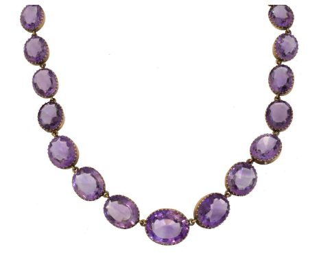 An amethyst rivière necklace, An amethyst rivière necklace, the graduated oval amethyst line with later fancy link chain side