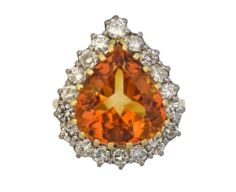 A citrine and diamond cluster ring, A citrine and diamond cluster ring, the pear shape citrine weighing approx. 8cts within a