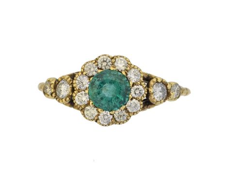 An emerald and diamond cluster ring,  An emerald and diamond cluster ring, the circular shape emerald weighing approx. 0.50ct