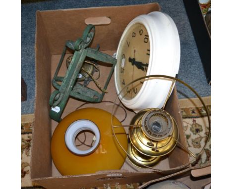 A Victorian brass oil lamp converted to electricity, a white painted school room clock and a brass bell with wrought iron bra