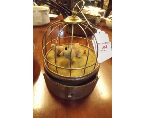 Automaton bird in brass cage. 