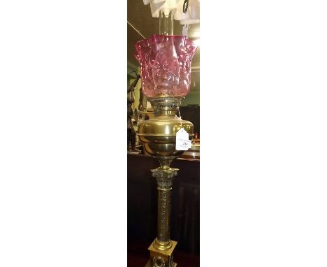 Victorian oil lamp with brass column and bowl and ruby glass tulip shade. 