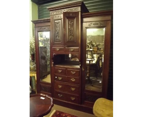 Victorian mahogany break front robe the two carved doors over two short drawers and shelf two short drawers and three graduat