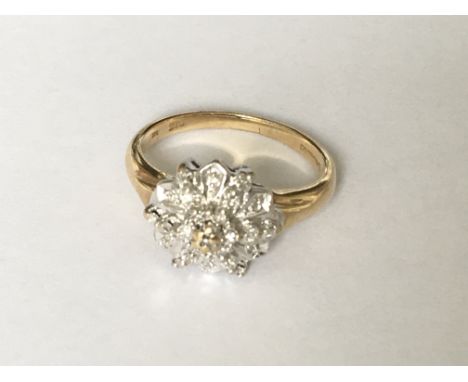 A circular all diamond set cluster ring in yellow and white gold