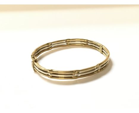 A 9ct gold two tone bangle approximately 14.5g.
