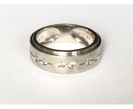 A modern style diamond set band ring in white gold