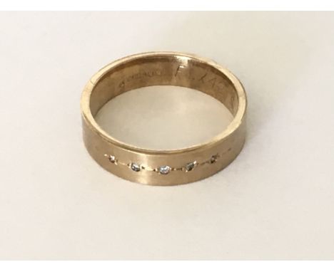A satin finished diamond set band ring