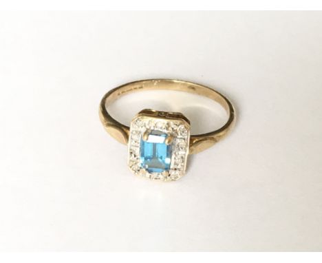 A rectangular blue topaz and diamond cluster ring