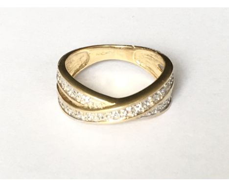 A crossover stone set ring in 9ct gold