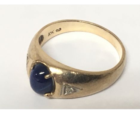 A 10k gold ring set with a blue stone cabochon and chip diamonds. ring size I weigh 4.5g