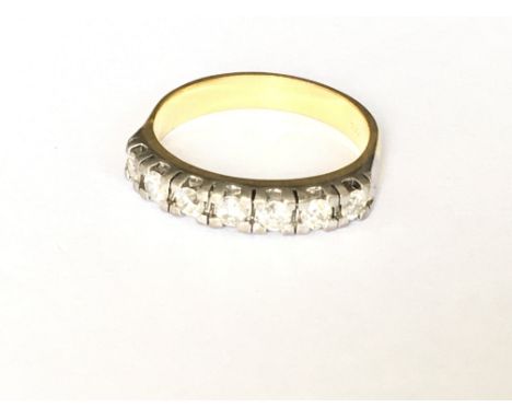 An 18ct 7 stone diamond set half hoop ring