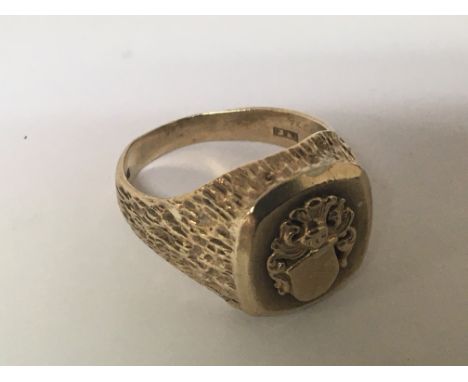 A 9carat gold ring with a raised crest. Weight 10g ring size S