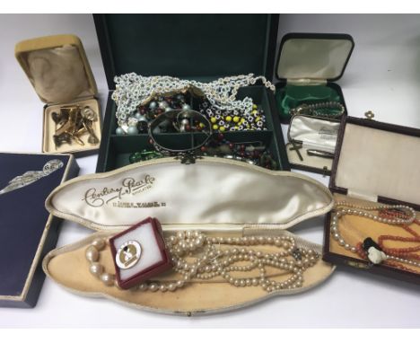 A Box containing collection of costume jewellery including bracelets and necklaces together with a cased photo frame watch an