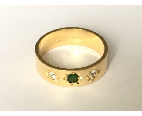 An emerald and diamond set ring in 18ct gold