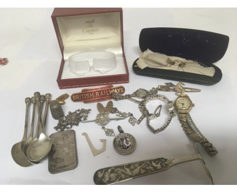 A collection of silver oddments including spoons a medallion brooches a Cartier watch box a ladies gold cased watch vintage s