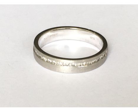 A modern 18ct white gold diamond set band ring