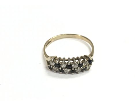 A 9ct gold ring set with alternating blue and clear stones, approx 2g and approx size Q-R.