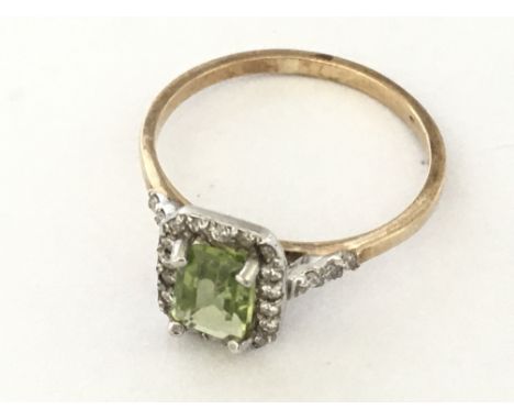 9ct white and yellow gold emerald cut peridot and R/C diamond cluster ring. Peridot 1.00ct, diamonds 0.24ct