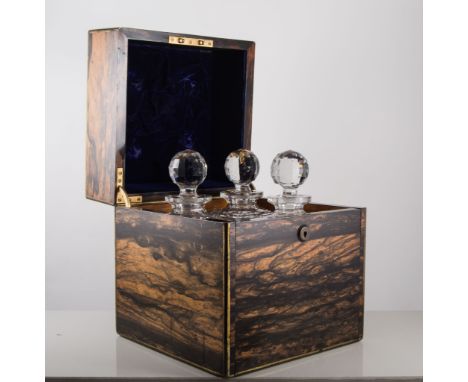 Coromandel decanter box,  with pull out four bottle tray, containing three hobnail decanters 23 x 26cm.