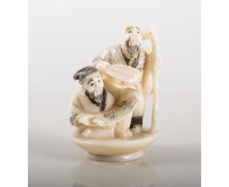 Small Japanese ivory Netsuke, figures with a scroll.