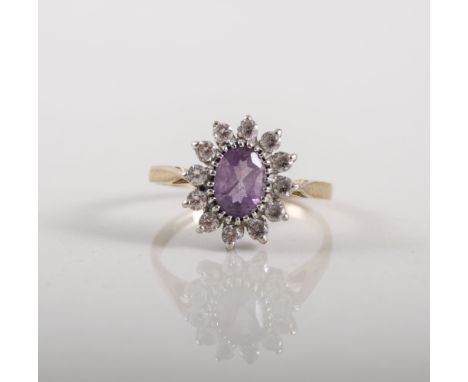 Ladies oval cluster ring, claw set with an oval mixed cut amethyst surrounded by synthetic white stones (12), gross weight ap