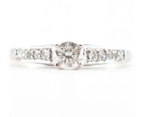 A hallmarked 18ct white gold and diamond solitaire ring. The ring set with a central round brilliant cut diamond&nbsp; having