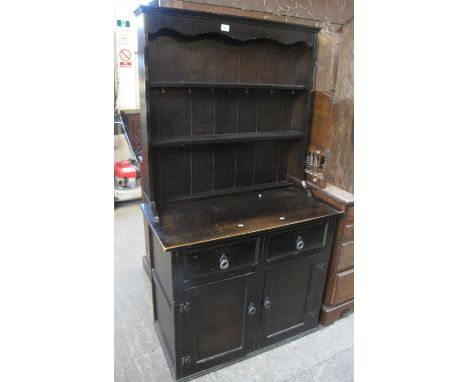 Small early 20th century oak dresser with boarded two shelf back, over two drawers and two blind panel cupboards.(B.P. 24% in