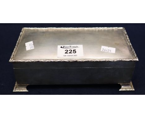 Silver engine turned cigarette box with foliate cast edge and wooden lining, 18cm across approx. 21.4 troy ozs approx includi