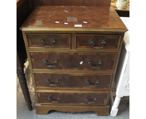 Reproduction yew wood straight front bedroom chest of two short and three long drawers on bracket feet, of narrow proportions
