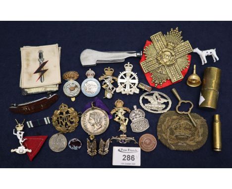 Small plastic box of assorted military insignia, enamel badges, cartridge etc. (B.P. 21% + VAT) 