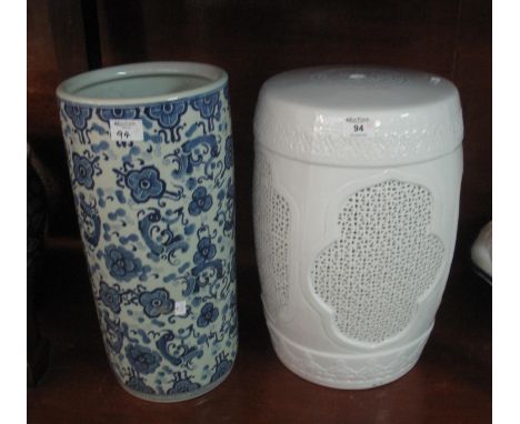 Chinese white glazed ceramic barrel shaped pierced garden seat, together with a Chinese blue and white foliate design cylindr