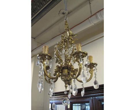 Gilt metal five branch Rococo style chandelier light fitting with prismatic glass droppers, together with a modern brass fram