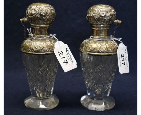 Pair of hob nail cut glass sterling silver mounted foliate repousse decorated atomiser pump action scent bottles. 16cm high a
